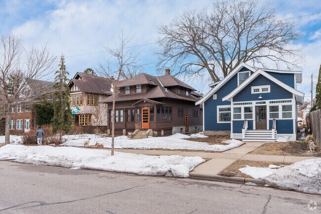 A blue craftsman home with white accents alongside other home styles.