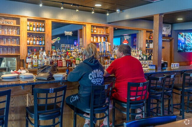 Folks dine at the bar at Grand Slam Bar in Wolfe Park.