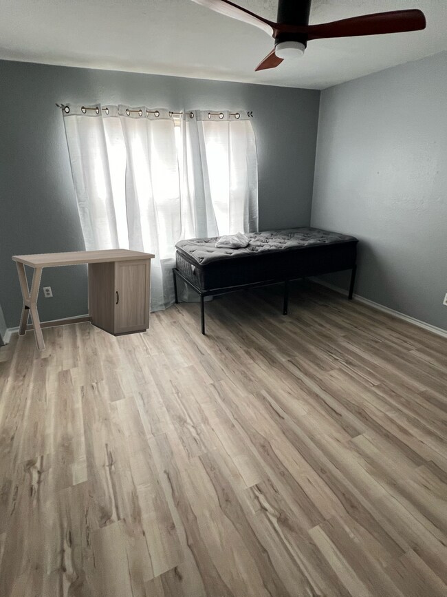Rental bedroom has two large closets, new flooring, new bed, new desk, new fan & fresh coat of paint