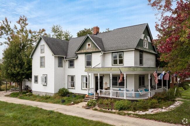 Historic homes line the streets of Milan, featuring farmhouses with Victorian influences.