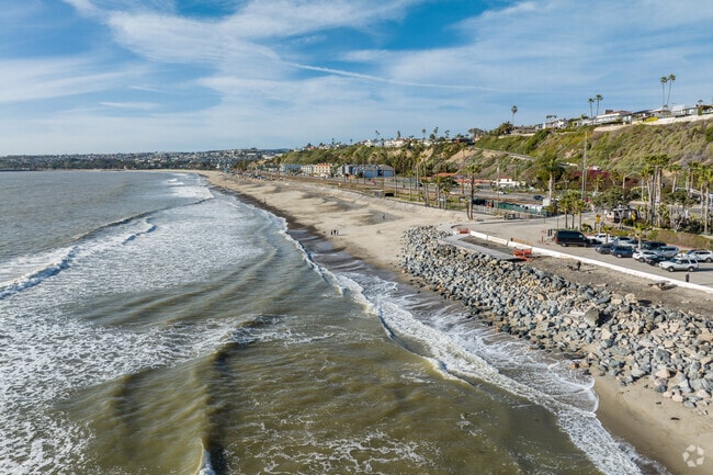 Watching the sun set over the Pacific at Capistrano Beach Park, you can stroll along the sandy shoreline, feel the ocean breeze, and enjoy a peaceful escape with breathtaking coastal views.