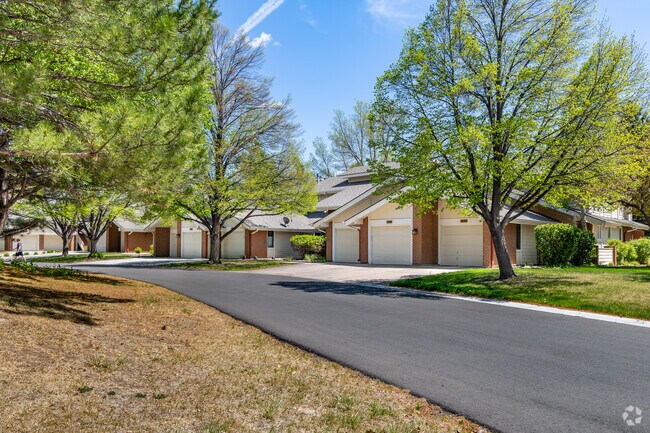 Condos in Southridge Greens sit along streets with tall evergreen, oak and aspen trees.
