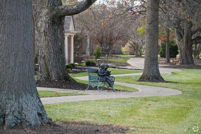 There are a few benches and statues within the outside of the building.