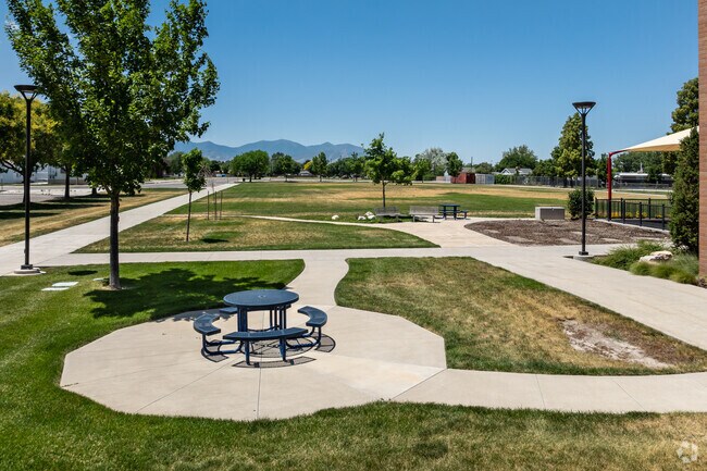 Hartvigsen School is surrounded by green space with lawns and trees.