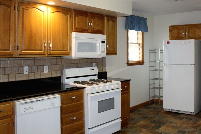 Kitchen with gas range and over the range microwave