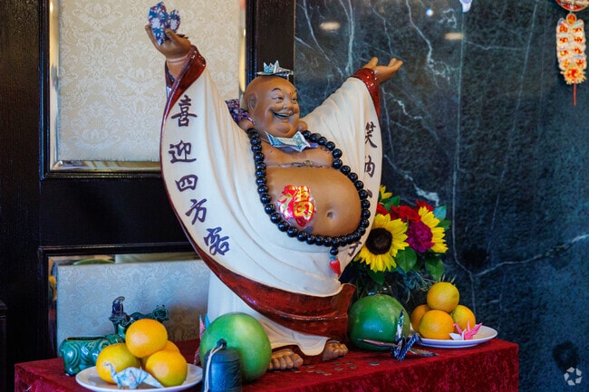 Red is the dominant color on this altar with a Buddha statue.