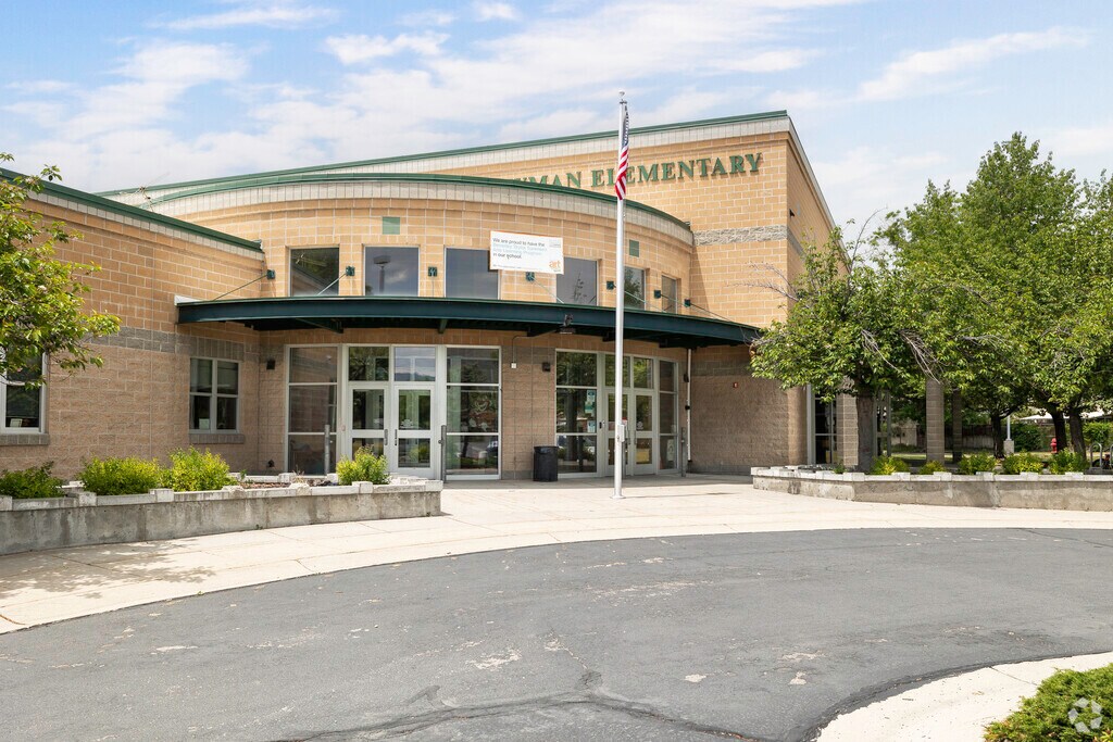 Curved lines of the entryway contrast against clean lines square shapes of the main building at Newman School in Rose Park.