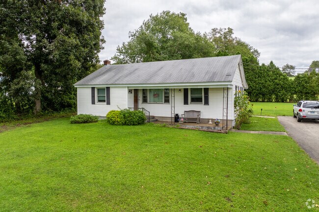 A white ranch-style home with a small porch sits in Franklin.