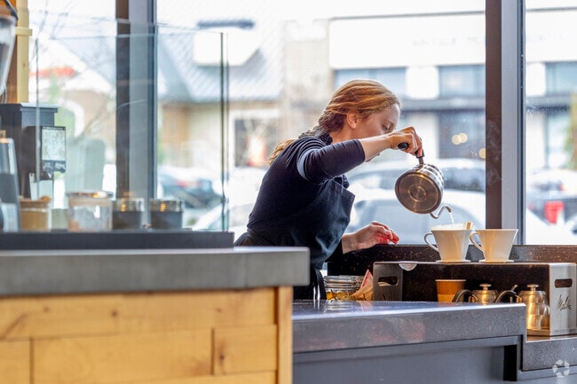 The Cup barista makes a pour over coffee for customers.