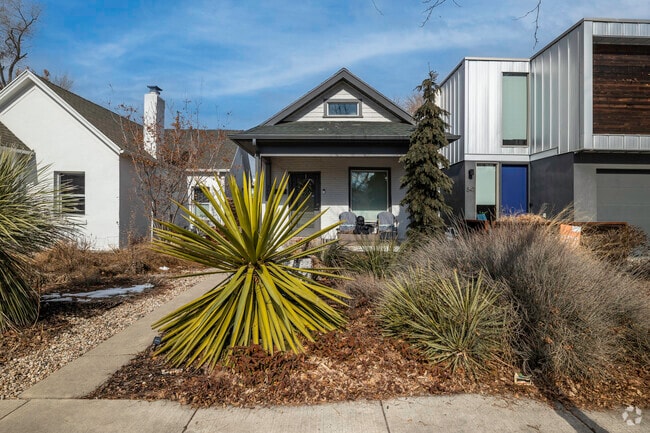 Craftsman style home with a large garden in the front yard.