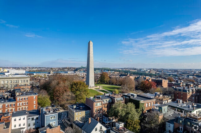 The Bunker Hill monument stands in the middle of a densely packed area.