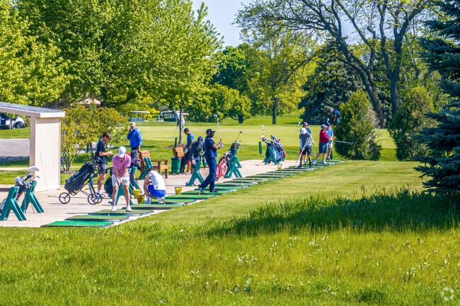 Golfers practice their swing at the Springbrook Golf Course in Naperville's Brighton Ridge area.