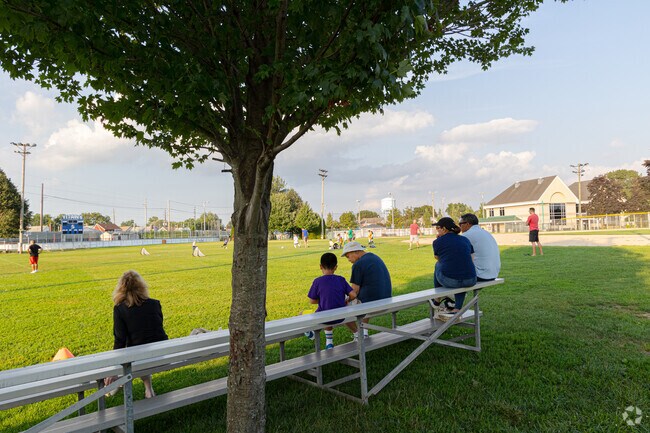 Parents watching young ones practicing in the Floral Park Recreation Center soccer field.