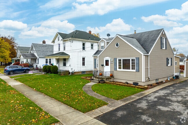 Hyde Park homes feature tidy front lawns and sidewalks that line quiet residential streets.