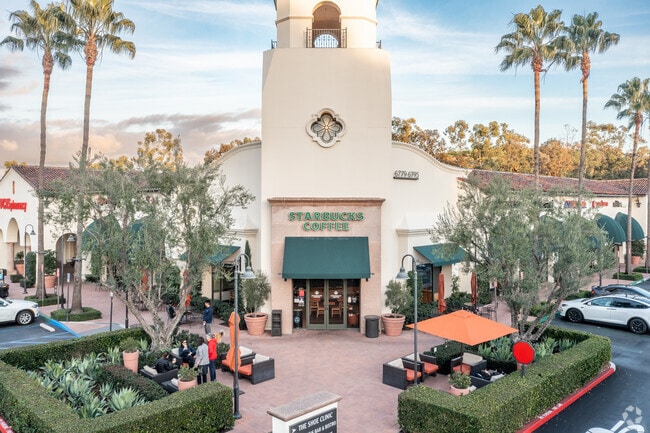 A Starbucks can be found in the corner of the Quail Hill Shopping Center.