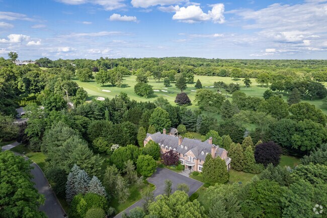 This colonial style estate sits against the Old Westbury Country Club.