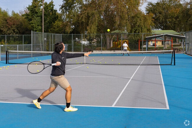 Two Tevis Ranch friends practice their tennis skills at the Campus Park South courts.