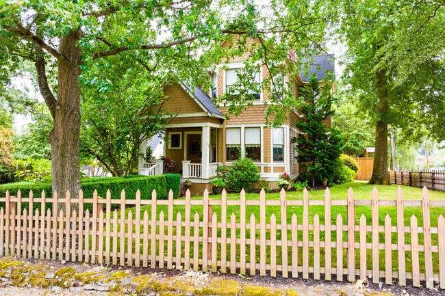 A picket fence frames a classic home on a quiet Dunlap street.