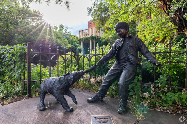 “One-On-One” is a captivating sculpture by Ann LaRose in West Pearl.