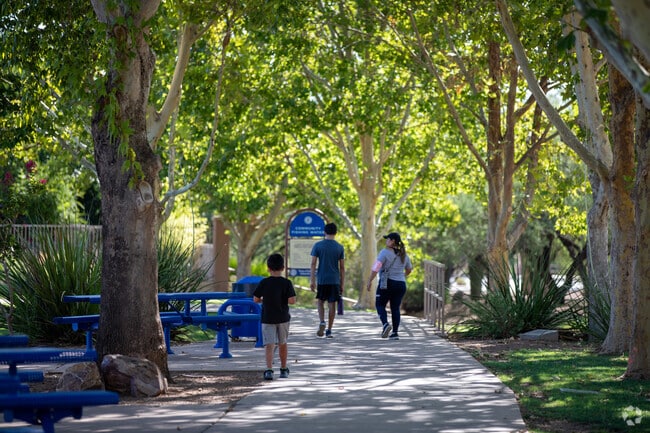Families stroll the shaded paths around Rancho Sahuarita Lake on weekend afternoons.