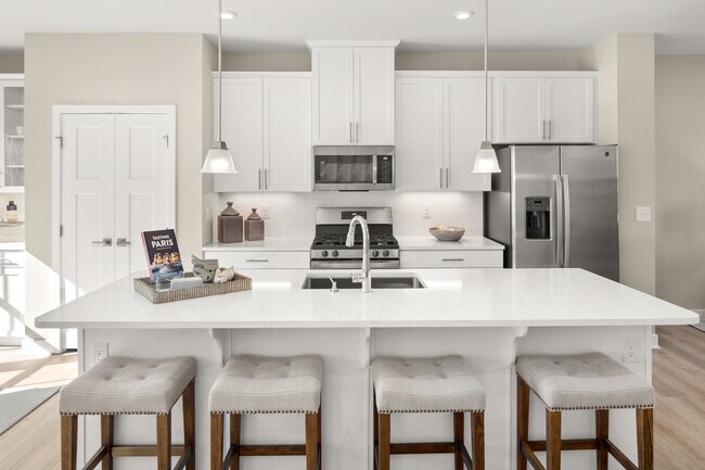 Your new kitchen includes 42 cabinets, quartz countertops, a large island, luxury vinyl plank flooring, and a stainless steel dishwasher, range, and microwave – all included!