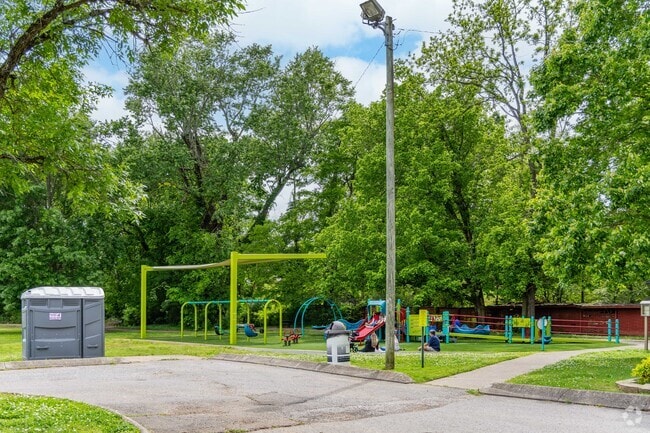 Families gather at Coy Lacy Park to play on the playground in Clarksville.