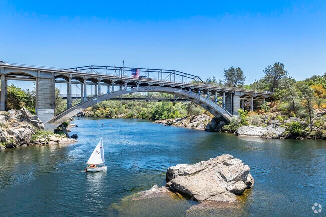 A charming historic bridge spans Lake Natomas, connecting downtown to American River Canyon in Folsom.