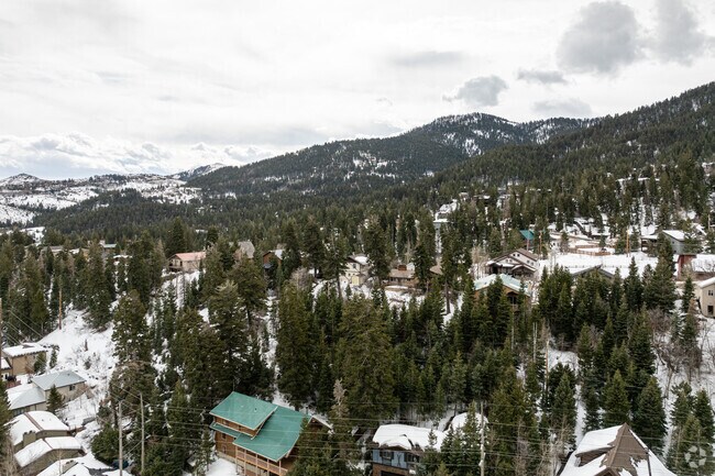 Summit Park is surrounded by mountains and trees.