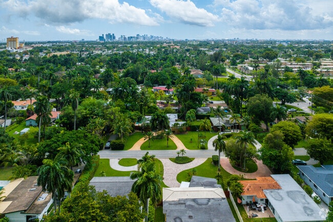Aerial view of a large El Portal home with the city of Miami in the background.