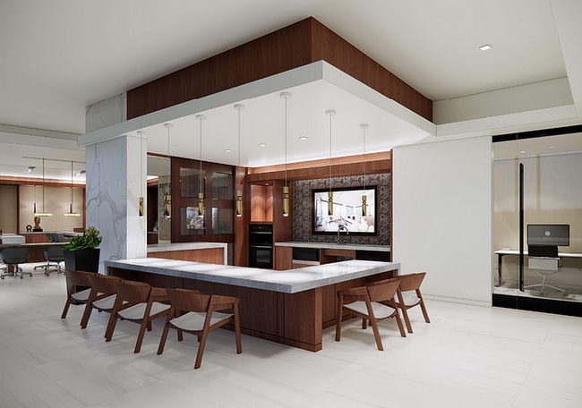 Elegant and modern open-concept cooking space with seating area fit for hosting and sophisticated decor.