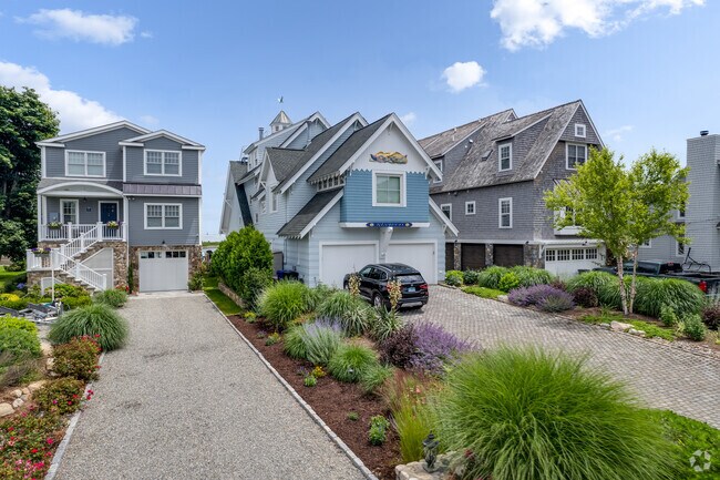 Attractive Harbor style homes with hedge lined driveways located in South Norwalk.