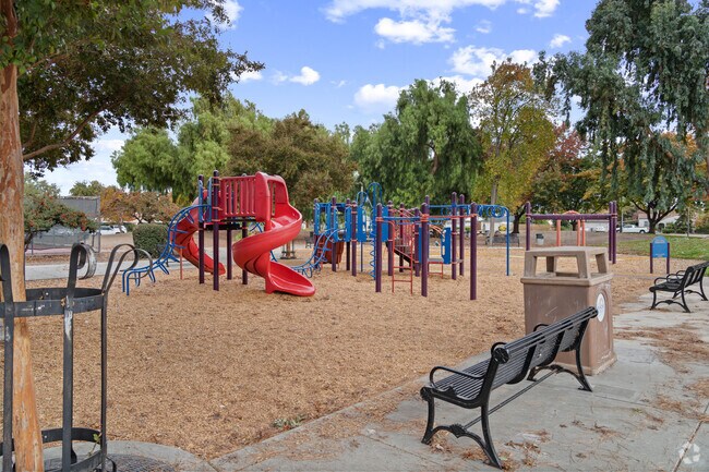 The kids’ playground at Cahalan Park features slides, swings, and shady trees for family fun.