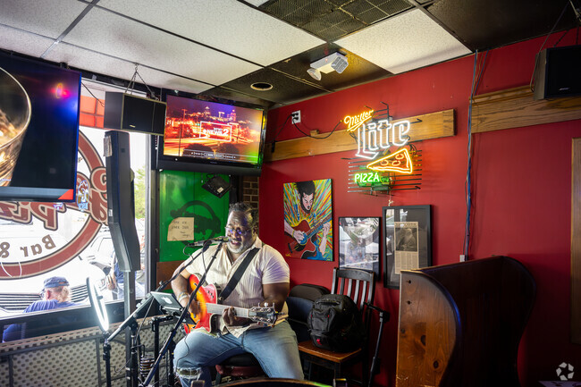 You can enjoy live music at George's Pizza Bar and Grill near Old Mill Estates.