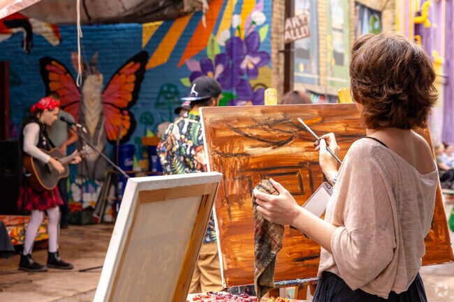 Artist share their painting techniques at the Alley Art Market in Oshkosh.