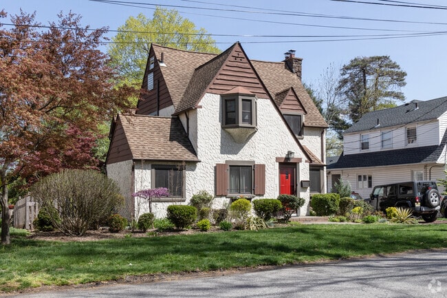 This Tudor style house in Tenafly, NJ has a cute red door.