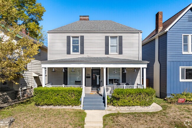 A two story home in Merion Village features a front porch.