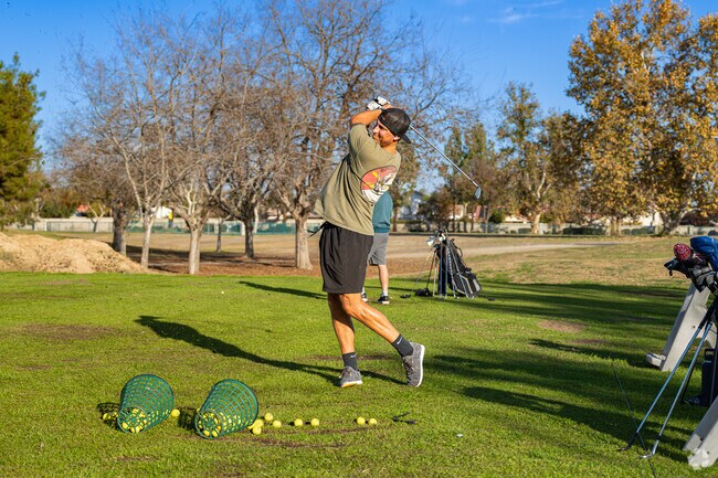 An Olive Drive Area golfer practices his swing at The Links at Riverlakes Ranch Golf Course.