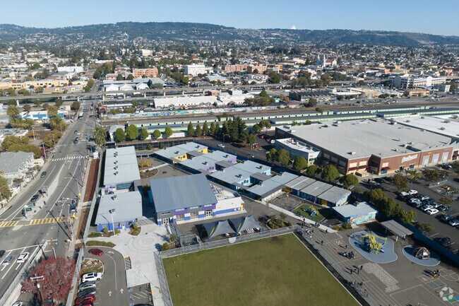 Lazear Charter Academy sits below the Oakland hills and is next to a shopping center.
