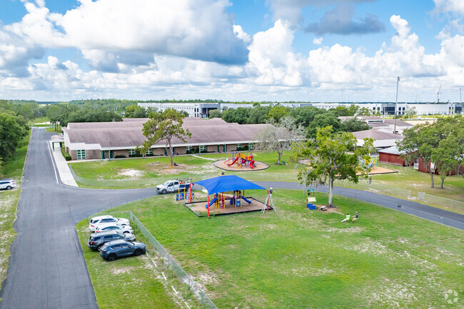 Kids enjoy playing on the play area at Mary Giella Elementary School .
