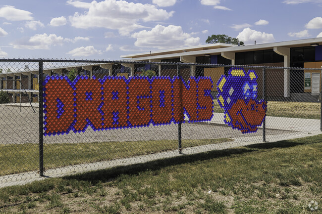 Howard Driggs School’s fence displays a colorful dragon along with the word spelled out.