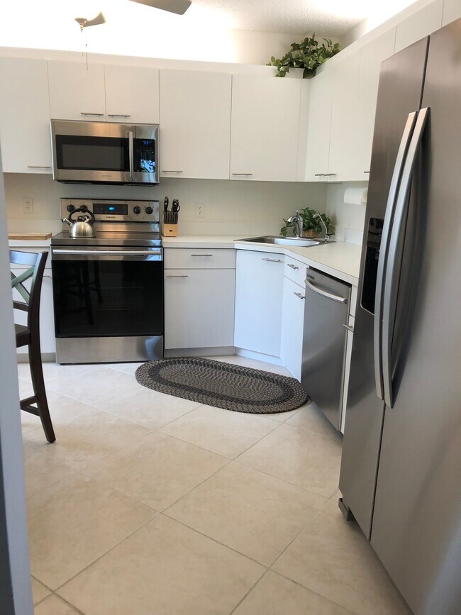 Large eat-in kitchen with Lots of cabinets space, all updated stainless steel appliances, ceiling fan, and garbage disposal.