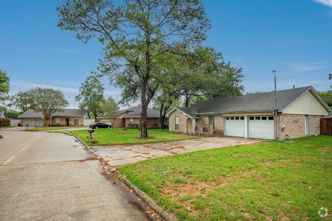 Mature oak and pine trees dot the yards of many ranch-style homes in Santa Fe, Texas.