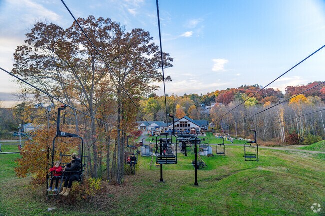 Locals make their way up on the chairlift in McIntyre Ski Area to the Weston Witch Tower.