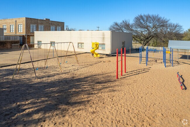 The Fogarty Elementary School playground, swings and monkey bars are for kids to play on.