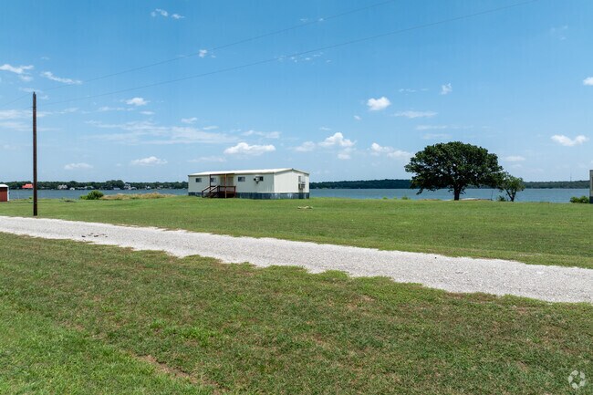 A mobile home by the lake in Pelican Bay neighborhood is a calm and simple retreat.
