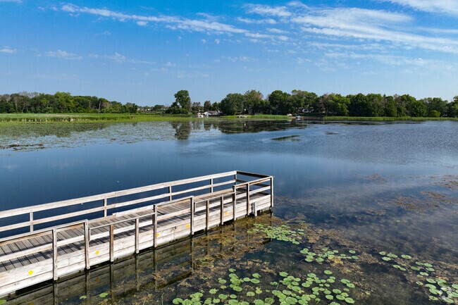 Anglers use the public fishing pier in Ham Lake Park.