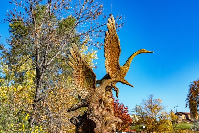 A waterfowl sculpture stands sentry over Lake George in downtown St. Cloud.