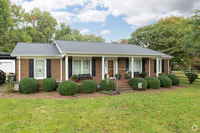 Autumn leaves sprinkle the lawn of a single-story home at The Orchard.