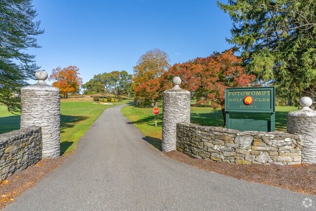 The entrance to Potowomut Golf Club welcomes with timeless elegance.