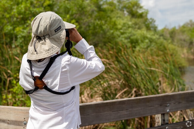 Bird watchers enjoy wildlife at Six Mile Cypress Slough Preserve near Cross Creek.